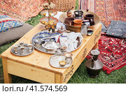 Tea ceremony at the Crimean Tatars, a table with a teapot, cups and food on red carpets. Стоковое фото, фотограф Андрей Журавлев / Фотобанк Лори