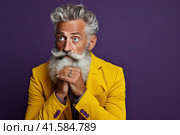 Portrait of an elderly man with a large gray beard and lush hair with a thoughtful look. Yellow jacket. Purple background. Generated by AI. Стоковое AI-изображение, AI-художник Ярославский Максим / Фотобанк Лори