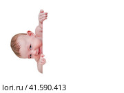 Sly baby in a crib with a angry look, isolated on a white background. Funny child, age six months. Стоковое фото, фотограф Андрей Журавлев / Фотобанк Лори