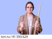 Sad woman teacher handcuffed on a blue background, copy space. Стоковое фото, фотограф Андрей Журавлев / Фотобанк Лори