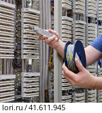 The PBX technician was able to quickly resolve the issue with the phone connection, keeping the office working smoothly. Стоковое фото, фотограф Андрей Журавлев / Фотобанк Лори