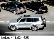 Silver Mitsubishi Pajero SUV car on the city road. Fast moving vehicle on Moscow streets. Offroad 4x4 auto. Compliance with speed limits on the road (2020 год). Редакционное фото, фотограф Константин Григорьев / Фотобанк Лори