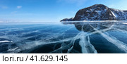 Frozen Lake Baikal. Panoramic view on transparent blue ice with cracks near Olkhon Island. Beautiful winter landscape. Natural cold background. Winter holidays, ice travel. Стоковое фото, фотограф Виктория Катьянова / Фотобанк Лори