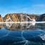 Frozen Lake Baikal. Panoramic view of beautiful mirror ice near Cape Hoboy - the northern tip of Olkhon Island at sunset. Beautiful winter landscape. Natural cold background. Winter holidays, ice travel. Стоковое фото, фотограф Виктория Катьянова / Фотобанк Лори