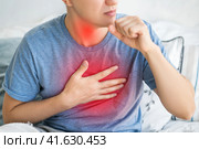 Sore throat and cough, man with lung pain at home. Стоковое фото, фотограф Станислав Тарко / Фотобанк Лори