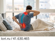 Intervertebral hernia, neck and lumbar pain, man suffering from backache at home, spinal disc disease. Стоковое фото, фотограф Станислав Тарко / Фотобанк Лори