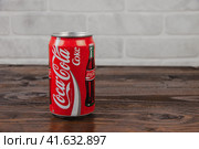 A vintage aluminium can of Coca-Cola soft drink against the brick wal (2020 год). Редакционное фото, фотограф Воловодов Владимир / Фотобанк Лори
