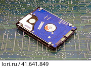 Hard disk on the background of the circuit board. Стоковое фото, фотограф Андрей Журавлев / Фотобанк Лори