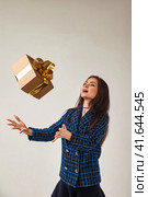 Perfect joyful lady in blue jacket throw up gift box at gray studio background, happy looking. Portrait of stylish woman model shows present emotion. Fashion style emotions concept. Copy ad text spa. Стоковое фото, фотограф Aleksandr Golubev / Фотобанк Лори