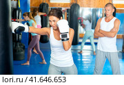 Asian woman training with punchbag. Стоковое фото, фотограф Яков Филимонов / Фотобанк Лори