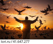 A man and a pigeon in flight against the background of the setting sun.Generated by AI. Стоковое AI-изображение, AI-художник Ярославский Максим / Фотобанк Лори