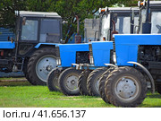 Tractor, standing in a row. Agricultural machinery. Стоковое фото, фотограф Леонид Еремейчук / Фотобанк Лори