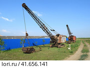 Old dragline near the blue fence. Стоковое фото, фотограф Леонид Еремейчук / Фотобанк Лори