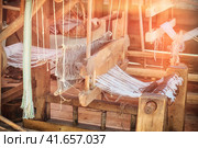 Retro loom for fabric making. Traditional vintage weaving machine for creating textiles. Стоковое фото, фотограф Андрей Журавлев / Фотобанк Лори