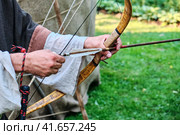 Archer in the clothes of a nomad is ready to shoot. Bow shooting for hunting and war. Стоковое фото, фотограф Андрей Журавлев / Фотобанк Лори