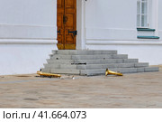 Left musical instruments on the ground near the building. Wind instruments lie on the road-trumpet, tuba, clarinet, flute. Стоковое фото, фотограф Андрей Журавлев / Фотобанк Лори