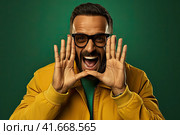Don't miss it. A young random man screams into the camera. Scream. Crying an emotional person screams against a dark background. A man's portrait from the waist up. Generated by AI. Стоковое AI-изображение, AI-художник Ярославский Максим / Фотобанк Лори