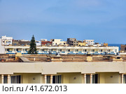 Hotel roofs and unfinished houses in an Arab city in the middle East. The upper floors of uncompleted buildings in Tunisia near the Mediterranean sea. Стоковое фото, фотограф Андрей Журавлев / Фотобанк Лори