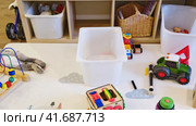 Children room littered with toys and a clean nurseryб stop motion. Mess due to toys scattered on the floor and things put away in a box, before and after cleaning. Стоковое видео, видеограф Андрей Журавлев / Фотобанк Лори