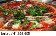 Delicious Meat Pizza with Red Tomato Sauce and Fresh Green Cilantro. BBQ Chicken Pizza with Barbecue Sauce, Mozzarella on Perfect Homemade Crust Closeup on the Wooden Board on the Table. Horizontal. Стоковое видео, видеограф Марина Демидюк / Фотобанк Лори