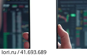 Black phone with blank mockup screen on rising stock graph. Closeup hand showing smartphone isolated white display. Online banking, Fund App use. Financial analyst on Invest Market. Bank collapse 2023. Стоковое видео, видеограф Марина Демидюк / Фотобанк Лори