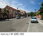 Cetinje, Montenegro - June 24, 2019. Perspective of Baja Pivljanina street with view of crashed car. Улица Бая Пивлянина в Цетине, Черногория. Стоковое фото, фотограф Александр Кузнецов / Фотобанк Лори