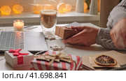 Female buyer makes order on laptop. Woman picking gifts online purchases at cozy home among gift boxes and packages. Winter sales, Black Friday. Christmas discount promotions. Blurred bokeh light. Стоковое видео, видеограф Марина Демидюк / Фотобанк Лори