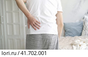Back pain, kidney inflammation, man suffering from backache at home, health problems concept. Стоковое видео, видеограф Станислав Тарко / Фотобанк Лори