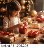 a little girl wraps Christmas gifts in craft paper. Стоковое AI-изображение, AI-художник Margarita Davchenko / Фотобанк Лори