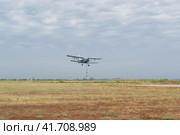 Волгоградская область, Средняя Ахтуба, Россия. Пейзаж, полёт лёгкого винтового пассажирского самолёта АН-2 в облачном небе. (2022 год). Редакционное фото, фотограф Андрей Цыганков / Фотобанк Лори