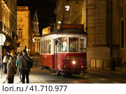 Lisbon, Portugal - red trolley car traveling down a street at nigth. Стоковое фото, фотограф Константин Шишкин / Фотобанк Лори