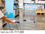 Abstract blurry photo of a supermarket with an empty shopping cart concept. Стоковое фото, фотограф Вербицкая Светлана / Фотобанк Лори