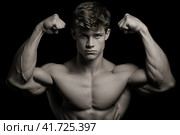 Ripped and Toned Young Man Flaunting his Well-Defined Muscles on a Stylish Monochrome Backdrop. Стоковое AI-изображение, AI-художник Игорь Кляхин / Фотобанк Лори