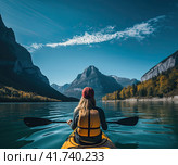 A girl on a yellow canoe is sailing on a mountain lake in calm weather. T Generated by AI. Стоковое AI-изображение, AI-художник Ярославский Максим / Фотобанк Лори