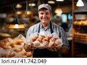The baker smiles and offers fresh pastries on a tray. Generated by AI. Стоковое AI-изображение, AI-художник Ярославский Максим / Фотобанк Лори