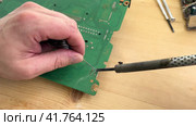 Close up Soldering a micro chip processor with iron tool on a green circuit boad. Electroncs service technology and macro computer concept background. Стоковое видео, видеограф Ирина Старикова / Фотобанк Лори
