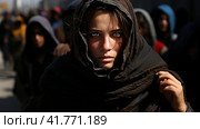 Portrait of Refugees on middle east looking at camera. Homeless people, unhappy and frightened, shawl camps,  Generative AI. Стоковое AI-изображение, AI-художник Анна Кривицкая / Фотобанк Лори