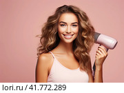 A young beautiful girl stands with a hair dryer on a pink monochrome background. Copy space. Стоковое AI-изображение, AI-художник Ярославский Максим / Фотобанк Лори