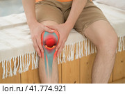 Knee pain, man suffering from osteoarthritis at home. Стоковое фото, фотограф Станислав Тарко / Фотобанк Лори