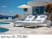 Sea view. Luxury modern white beach hotel with swimming pool. Sunbed on sundeck for vacation home or hotel. Стоковое AI-изображение, AI-художник Ирина Михайличенко / Фотобанк Лори