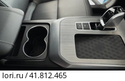 A transmission shift knob and wireless phone charger. Intimate Cabin Experience, Luxurious Driver Seat and Dashboard. Стоковое видео, видеограф Даниил Хабаров / Фотобанк Лори