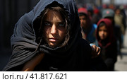Portrait of Refugees on middle east looking at camera. Homeless people, unhappy and frightened, shawl camps,  Generative AI. Стоковое AI-изображение, AI-художник Анна Кривицкая / Фотобанк Лори