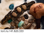 handmade stone runes on white fur. Стоковое фото, фотограф Boris Vasilenko / Фотобанк Лори