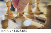 The capture of the black bishop by the white pawn in a chess game. Man hand with a chess piece in a board game. Стоковое видео, видеограф Андрей Журавлев / Фотобанк Лори