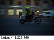 Motorcyclist on the BMW R1200 GS motorcycle driving on the night city street. Exceeding the speed limit is not allowed. Редакционное фото, фотограф Константин Григорьев / Фотобанк Лори