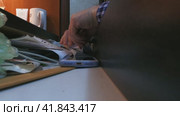 A man's hand opens a desk drawer and counts out several hundred-dollar bills. The concept of household finance. Стоковое видео, видеограф Ярославский Максим / Фотобанк Лори