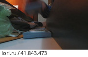 A drawer opens and a man's hand puts a stack of hundred-dollar bills, a phone and documents in it. Стоковое видео, видеограф Ярославский Максим / Фотобанк Лори