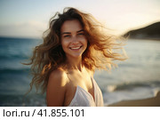 Beautiful smilling young woman with wind fluttering hair on summer beach at sunset close up. Health, relaxation, travel concept. Стоковое AI-изображение, AI-художник Оксана Гильман / Фотобанк Лори