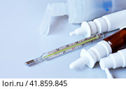 Thermometer with high temperature readings and various sprays and a nebulizer for the treatment of pneumonia, allergies and coronavirus infection. Copy space, close-up, top view. Стоковое фото, фотограф Виктория Катьянова / Фотобанк Лори