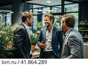 Young colleagues communicate in the spacious foyer of the office. They smile at each other. The concept of business communication. Стоковое AI-изображение, AI-художник Ярославский Максим / Фотобанк Лори